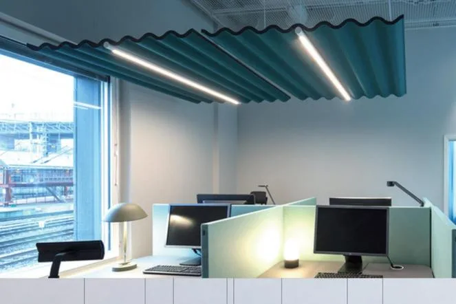 Office ceiling fitted with teal wave acoustic baffles
