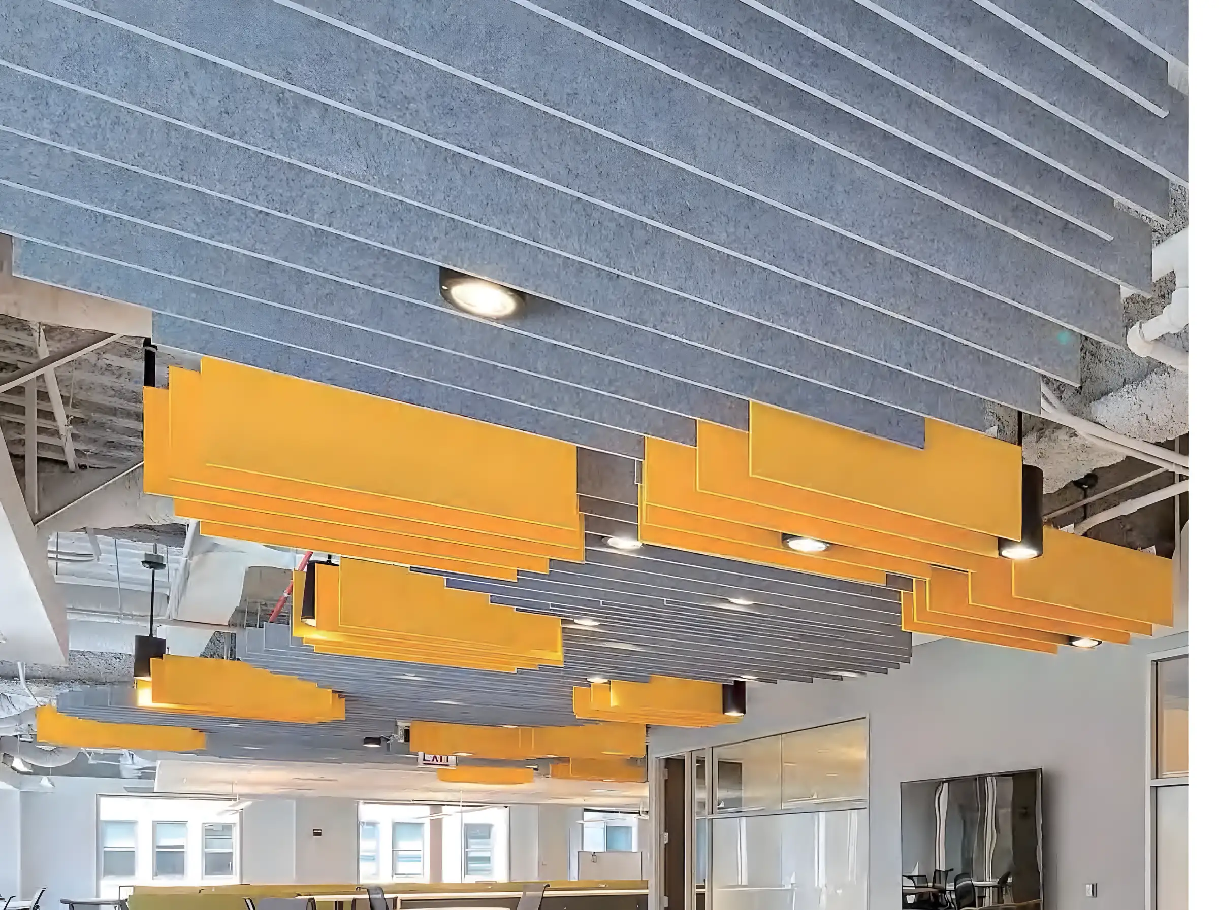 Acoustic baffles suspended from the ceiling of an open-plan office
